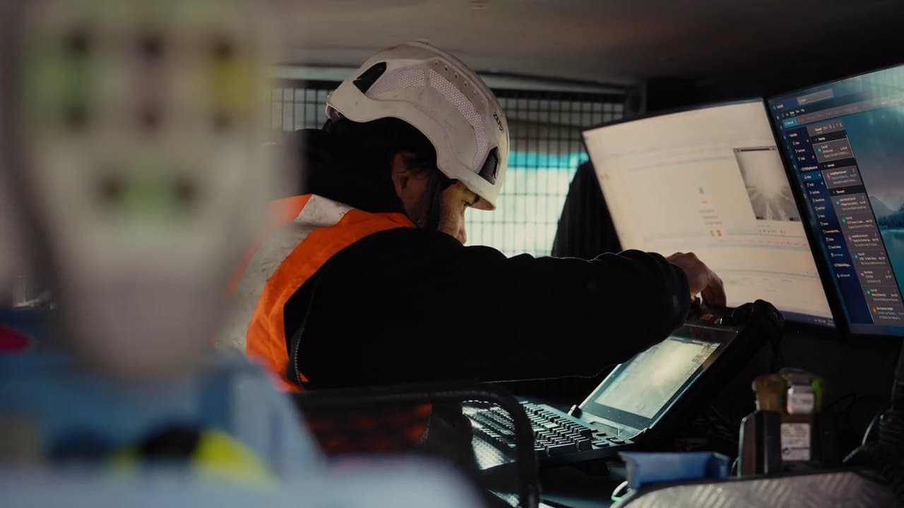 CCTV operator reviewing pipe footage in the camera van